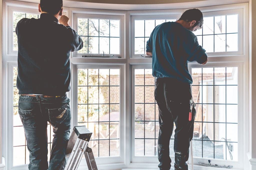 Two of our Joiners fitting a timber casement window