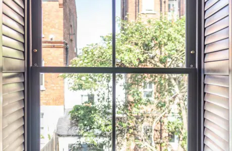 Wooden-traditional-sash-window-with-plantation-shutters-683x1024