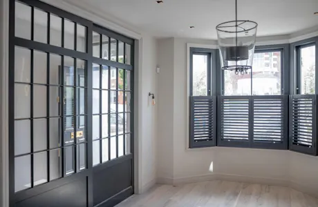 living-room-with-timber-bay-window-with-plantation-shutters-and-internal-georgian-doors-and-screen-1024x683