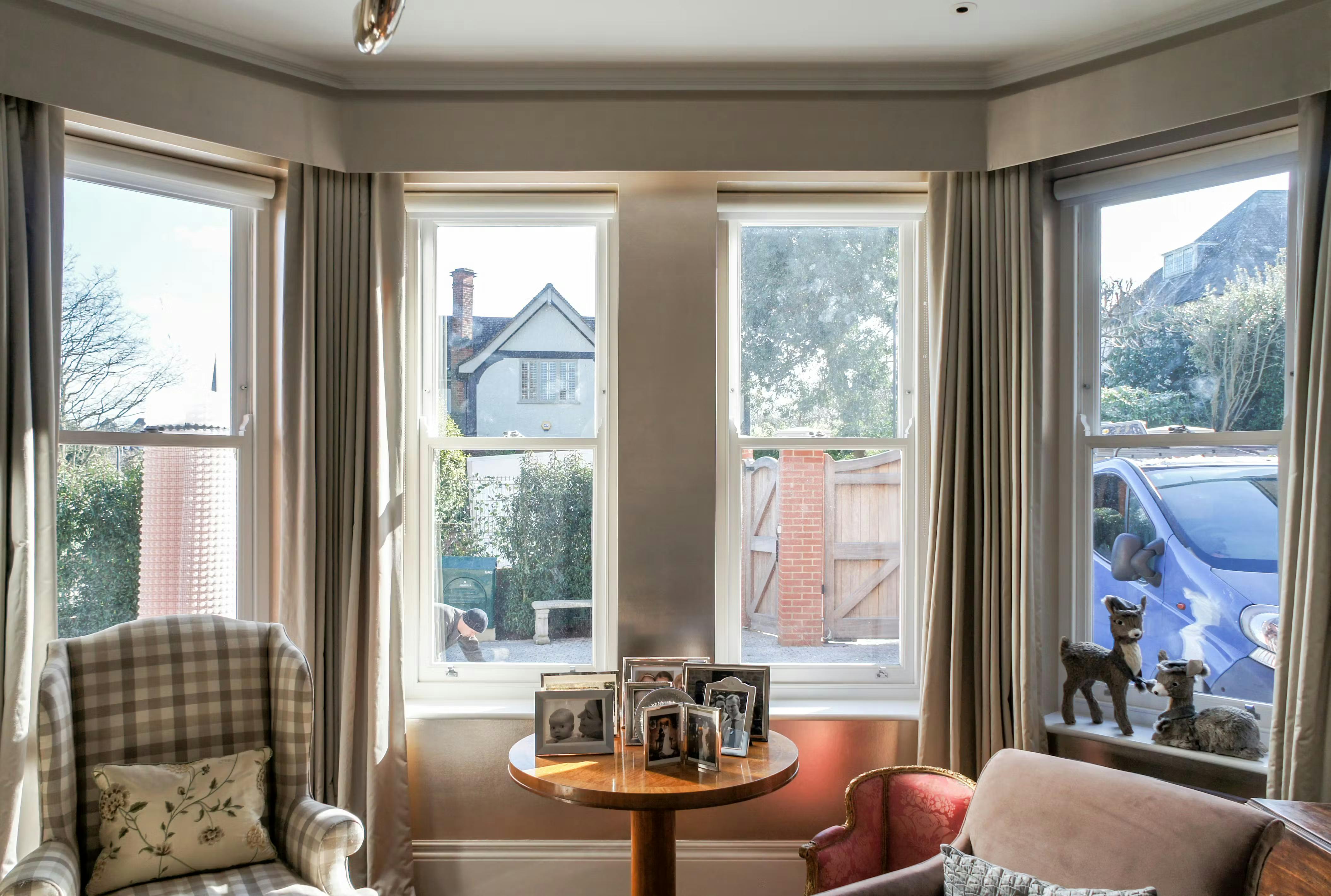 roller blinds with curtains on a bay sash window